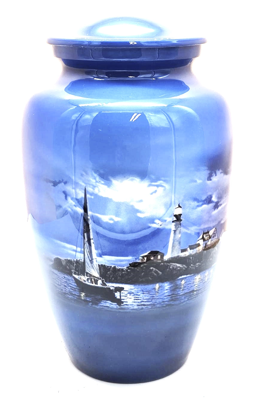 Lighthouse Adult Cremation Urn "Safe Passage" | Sailboat being guided by the Lighthouse